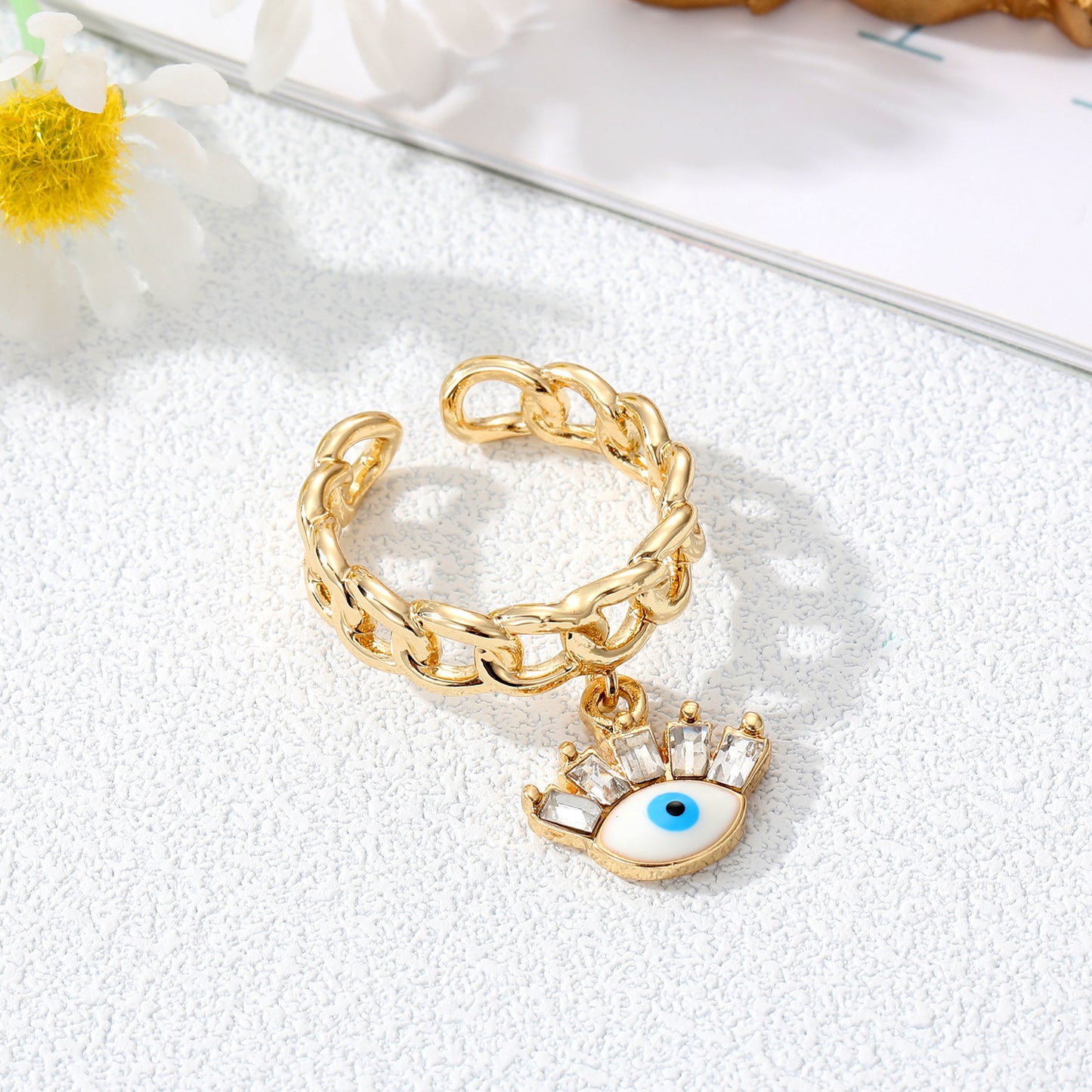 Juego de anillos con dije de mal de ojo dorado