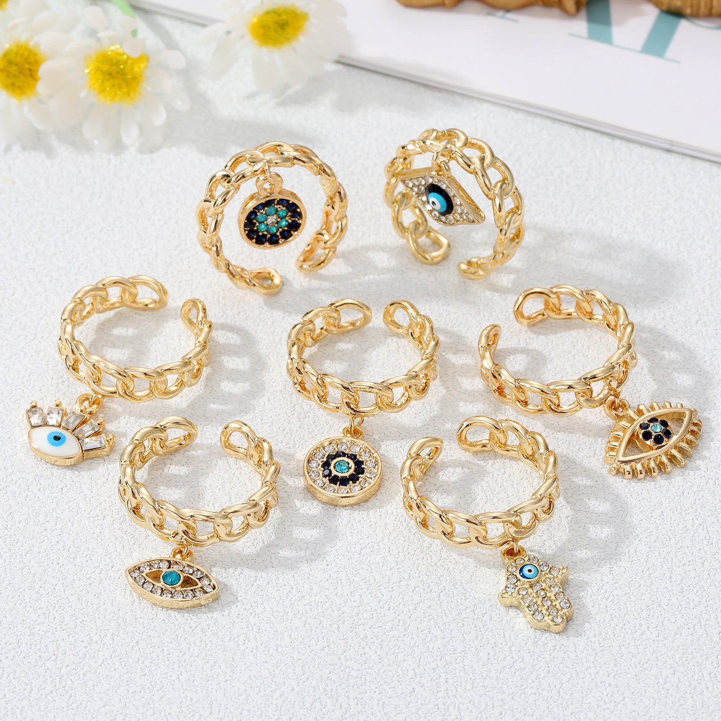 Juego de anillos con dije de mal de ojo dorado