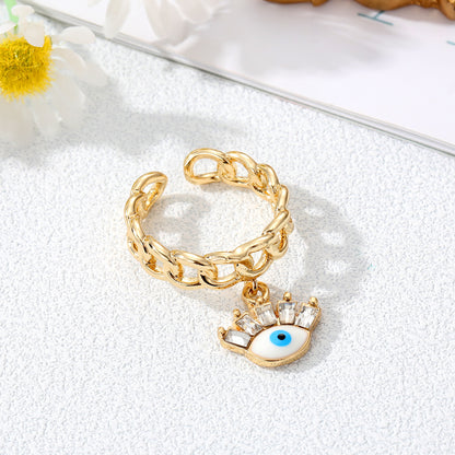 Juego de anillos con dije de mal de ojo dorado