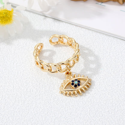 Juego de anillos con dije de mal de ojo dorado