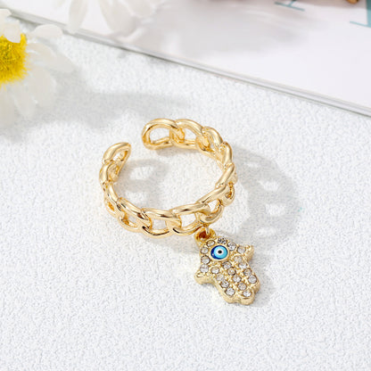 Juego de anillos con dije de mal de ojo dorado